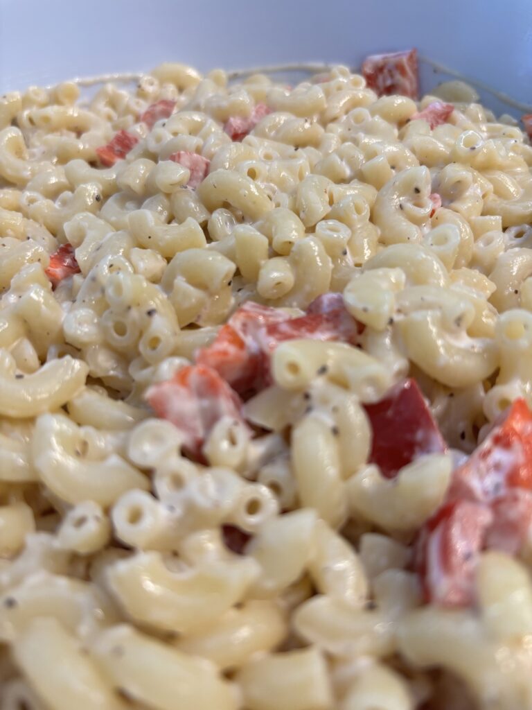 A closeup of macaroni salad in a bowl